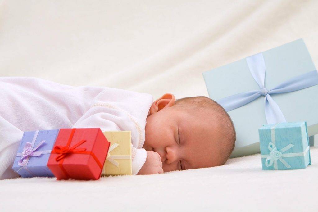 Colorful gift boxes with sleeping baby